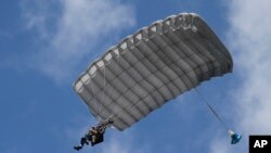Tom Rice, a 98-year-old American WWII veteran, front left, approaches the landing zone during a tandem parachute jump near Groesbeek, Netherlands, Sept. 19, 2019.