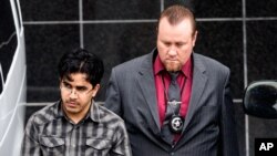 FILE - Omar Faraj Saeed Al Hardan, left, is escorted by U.S. Marshals from the Bob Casey Federal Courthouse, in Houston, Jan. 8, 2016. 