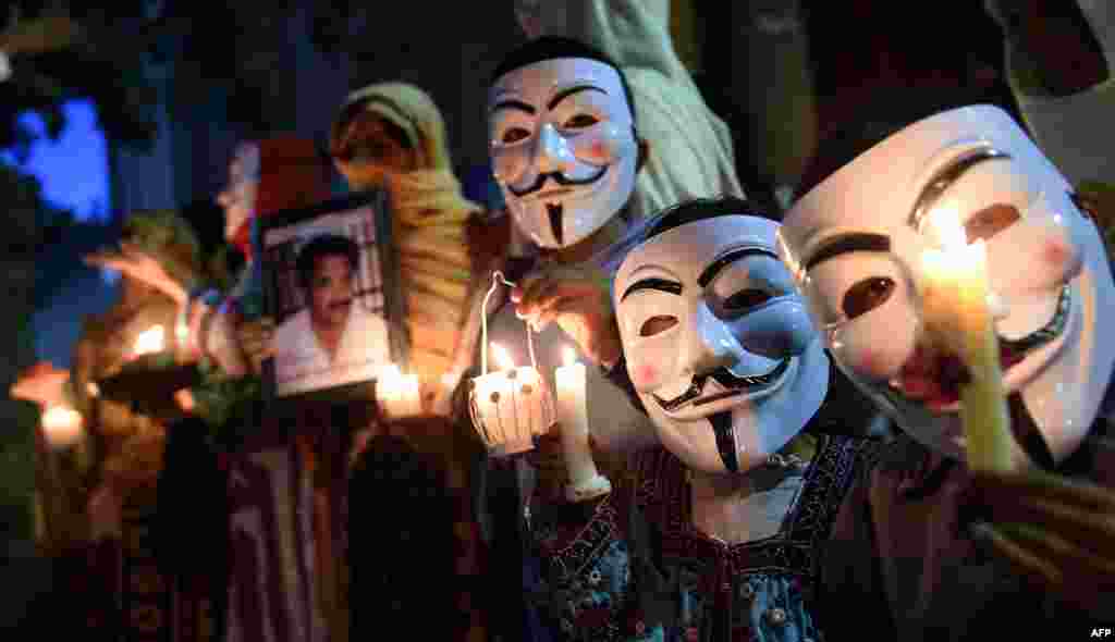 Relatives of missing Pakistanis wear Guy Fawkes masks as they observe Baloch Martyrs Day in Quetta.