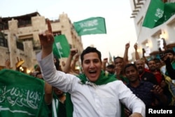 Saudi Arabia fans celebrate in Souq Waqif after the match between Saudia Arabia and Argentina on November 22, 2022. (REUTERS/Pedro Nunes)