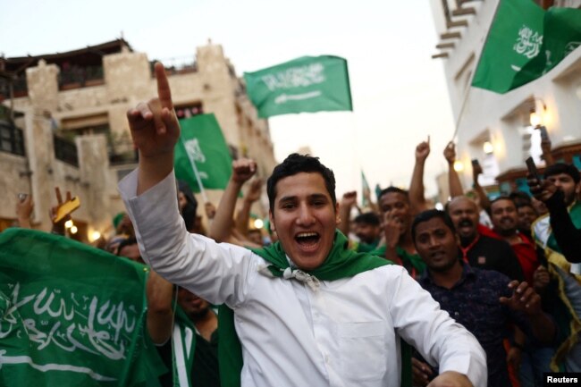 Saudi Arabia fans celebrate in Souq Waqif after the match between Saudia Arabia and Argentina on November 22, 2022. (REUTERS/Pedro Nunes)