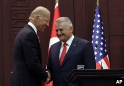U. S. Vice President Joe Biden, left, and Turkish Prime Minister Binali Yildirim shake hands after a joint news conference in Ankara, Turkey, Aug. 24, 2016.