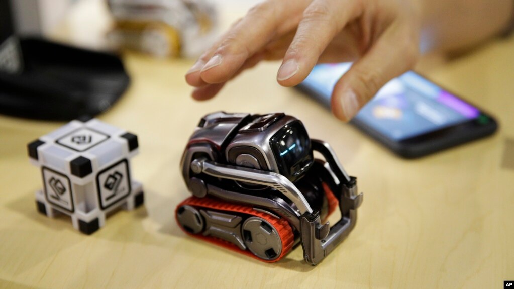 FILE- In this Jan. 10, 2018, file photo, Anki Cozmo coding robot is on display at CES International in Las Vegas. Cozmo, which debuted in 2016, now comes with an app called Code Lab that allows kids to drag and drop blocks of code that control its movements and animations.