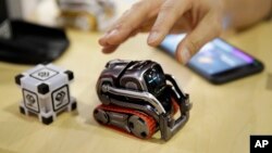FILE- In this Jan. 10, 2018, file photo, Anki Cozmo coding robot is on display at CES International in Las Vegas. Cozmo, which debuted in 2016, now comes with an app called Code Lab that allows kids to drag and drop blocks of code that control its movements and animations.