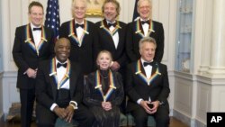 The 2012 Kennedy Center Honorees, from left, John Paul Jones, Buddy Guy, Jimmy Page, Natalia Makarova, Robert Plant, Dustin Hoffman, and David Letterman pose for a group photo Dec. 1, 2012 at the State Department in Washington.