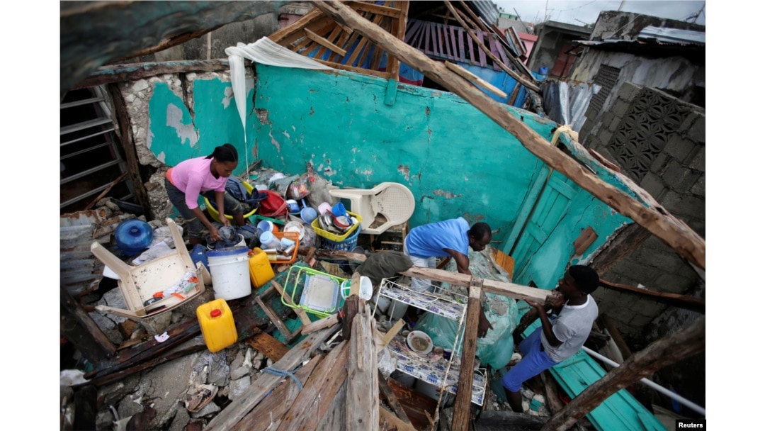 Residents work clearing a house destroyed by Hurricane Matthew in Les Cayes, Haiti, Oct. 5, 2016.