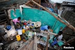 Residents work clearing a house destroyed by Hurricane Matthew in Les Cayes, Haiti, October 5, 2016.