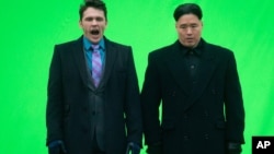 FILE - Actor James Franc (L) yawns before filming a scene with an actor playing North Korean leader Kim Jong Un for the movie "The Interview," at Robson Square in Vancouver, British Columbia.