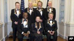 The 2012 Kennedy Center Honorees, from left, John Paul Jones, Buddy Guy, Jimmy Page, Natalia Makarova, Robert Plant, Dustin Hoffman, and David Letterman pose for a group photo, December 1, 2012 at the State Department in Washington.