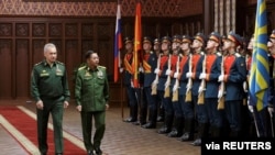 Russia's Defense Minister Sergei Shoigu and Myanmar's Min Aung Hlaing walk past the honor guard prior to their talks in Moscow, June 22, 2021. (Vadim Savitskiy/Ministry of Defense of the Russian Federation/Handout via Reuters)