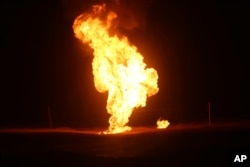 FILE - Flames leap into the air after a natural gas pipeline explodes outside the city of Boroujen in the western Chaharmahal and Bakhtiari province, Iran, in early February 14, 2024.