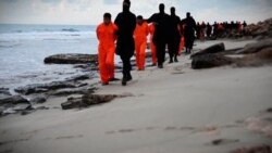 FILE - Islamic State prisoners in orange jumpsuits are marched along a beach said to be near Tripoli, in this still image from an undated video made available on social media, Feb. 15, 2015.