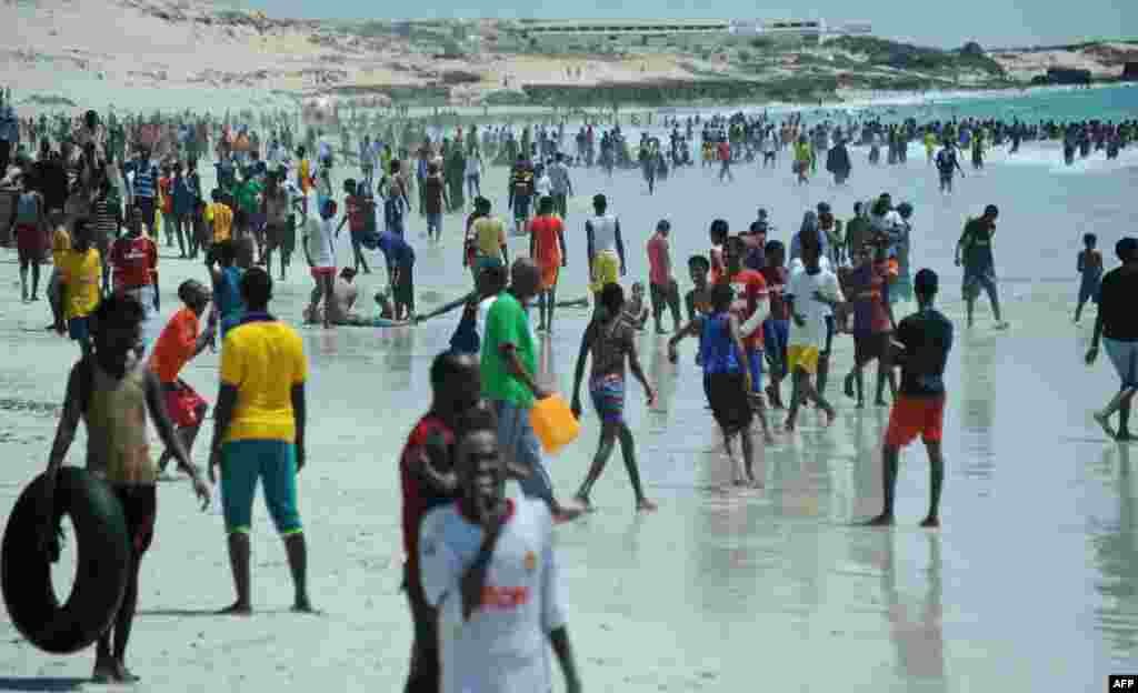 Residents relax on Lido beach along the Indian Ocean's coastal city of Mogadishu, Somalia. Lido Beach has become a popular spot over the weekend, with hundreds of people gathering to enjoy the sea and sand.