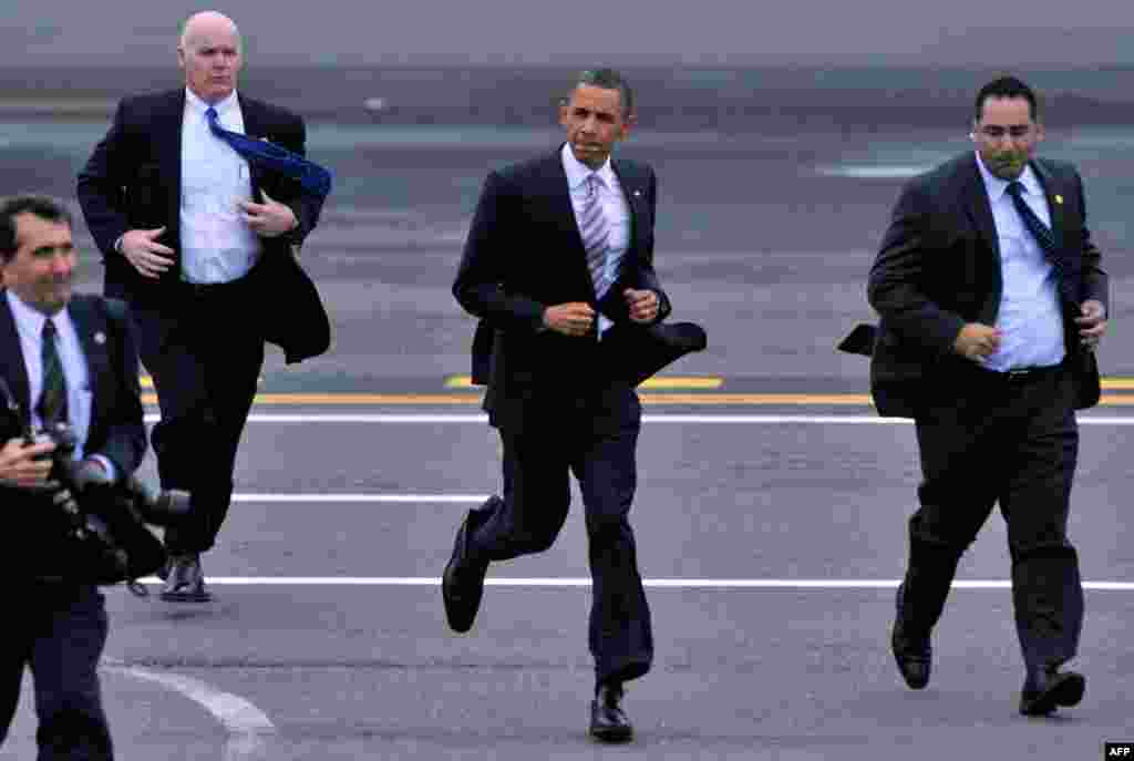 May 18: President Barack Obama jogs from Air Force One to a group of supporters who came to meet the President at Logan Airport in Boston. (AP)