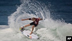 FILE - Hawaiian surfer Mick Fanning competes in the 2015 Oi Rio Pro World Surf League competition at Barra da Tijuca beach in Rio de Janeiro, Brazil, May 12, 2015.