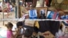 Cambodian refugee children play under a tent at a refugee camp of Ta Keung village, about 70 kilometers (43 miles) south of Cambodia's 11th century Hindu Preah Vihear temple near the deputed border between Cambodia and Thailand, in Preah Vihear province, 