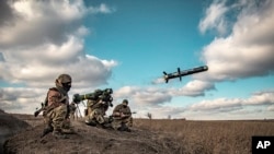 FILE - Ukrainian soldiers use a launcher with US Javelin missiles during military exercises in Donetsk region, Ukraine, in this image released Dec. 23, 2021, by Ukrainian Defense Ministry Press Service.