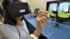 A journalist tries to use the new device using 3D-heptics technology which gives users tectale and kinethetic feeling virtually at a press preview in Tsukuba, suburban Tokyo on September 1, 2014. Japan's high-tech venture Miraisens unveiled a 3D technolog