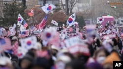 FILE - Supporters of impeached South Korean President Yoon Suk Yeol shout slogans during a rally to oppose his impeachment near the Constitutional Court in Seoul, South Korea, Jan. 14, 2025.