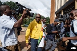 Zimbabwe cleric and activist Pastor Evan Mawarire arrives at the Harare Magistrates Court on January 17, 2019, to appear in court, accused of inciting violence through social media, after he was arrested by armed police at his home in Harare