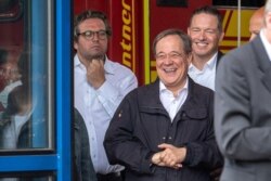 CDU leader and North Rhine-Westphalia's State Premier Armin Laschet laughs as the German president (unseen) delivers a speech during their visit to flood-hit Erftstadt, Germany July 17, 2021.