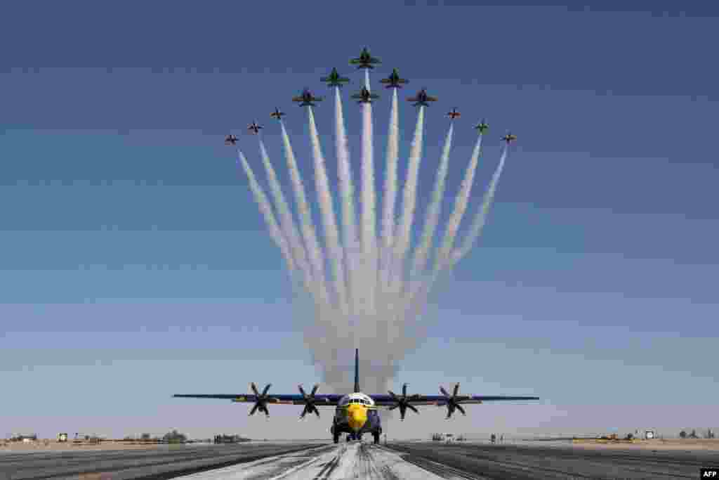 This handout image of the U.S. Air Force shows the U.S Air Force Air Demonstration Squadron &quot;Thunderbirds&quot; and the U.S. Navy Flight Demonstration Squadron &quot;the Blue Angels&quot; perform the Super Delta formation over a C-130J Super Hercules at Naval Air Facility El Centro, March 2, 2021.&nbsp;