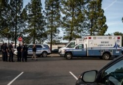 A group of ambulances from the Solano EMS Cooperative stage at the visitor center at Travis Air Force Base, adjacent to Fairfield, California, Feb. 16, 2020.