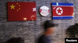 FILE: Flags of China and North Korea are seen outside the closed Ryugyong Korean Restaurant in Ningbo, Zhejiang province, China, April 12, 2016.