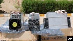 This undated photo provided by the Police News Agency, shows boxes of machinery used in Bitcoin "mining" operations that were confiscated by police in Nazarabad, Iran. (News.police.ir via AP)