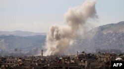 Smoke billows following a reported air strike in the rebel-held parts of the Jobar district, on the eastern outskirts of the Syrian capital Damascus, March 19, 2017.