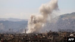 Smoke billows following a reported air strike in the rebel-held parts of the Jobar district, on the eastern outskirts of the Syrian capital Damascus, March 19, 2017.