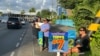 Palauans line the streets of the commercial city of Koror ahead of Palau's Nov. 5 general elections.