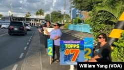 Palauans line the streets of the commercial city of Koror ahead of Palau's Nov. 5 general elections.