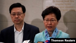  Hong Kong Chief Executive Carrie Lam, right, and Secretary for Security John Lee Ka-chiu speak to media over an extradition bill in Hong Kong, July 2, 2019.