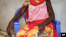 FILE - A young woman says that on a day in early November she and a friend were bound, dragged into the bush and raped by four men with guns, as she sits in a hospital in Nhialdu, South Sudan, Dec. 7, 2018.