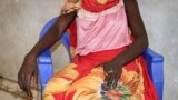 FILE - A young woman says that on a day in early November she and a friend were bound, dragged into the bush and raped by four men with guns, as she sits in a hospital in Nhialdu, South Sudan, Dec. 7, 2018.