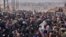 Syrian families, fleeing from various eastern districts of Aleppo, queue to get onto governmental buses, Nov. 29, 2016, in the government-held eastern neighborhood of Jabal Badro, before heading to government-controlled western Aleppo. The crisis in Syria is currently the United Nations' biggest humanitarian concern.