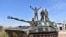 FILE - In this photo released by the Syrian official news agency SANA, Syrian army soldiers flash the victory sign as they stand on their tank in the village of Kfar Nabuda, in the countryside of Hama province, Syria, May 11, 2019.