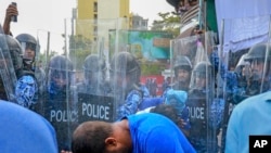 FILE - Police use pepper spray to disperse pro-opposition supporters during a protest in Male, Maldives, Feb. 16, 2017.