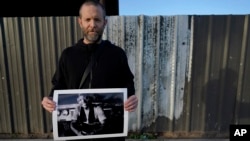 Documentary photographer Eric Elmore displays one of his images of Roosevelt White III, Dec 19, 2023, in Phoenix. White is among thousands of homeless people who died this year and are being remembered at winter solstice events for Homeless Persons' Memorial Day. 