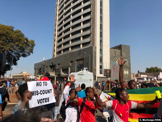 FILE - Protesters argue that election results are false and that opposition leader Nelson Chamisa is the true winner, in Harare, Aug. 1, 2018.