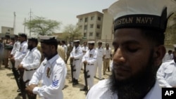 Pakistai Navy officers pay tribute to their colleague who was killed during a militant seige on a Karachi naval base at a funeral in Lahore, Pakistan, May 23, 2011.