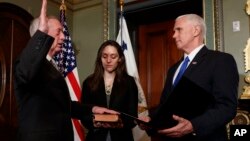Vice President Mike Pence administers the oath of office the Defense Secretary James Mattis, Jan. 20, 2017, in the Vice Presidential Ceremonial Office in the Eisenhower Executive Office building on the White House grounds in Washington. 