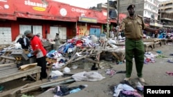 A policeman secures the scene of twin explosions at the Gikomba open-air market for second-hand clothes in Kenya's capital Nairobi, May 16, 2014.