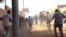 People run as tear gas canisters are thrown at them during an anti-government protest in Omdurman, Sudan, Jan. 9, 2019, in this still image taken from social media.