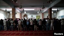 Muslims pray inside the Greek-Arabic educational cultural center at Moschato suburb in Athens May 24, 2013. 
