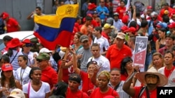 Supporters of Venezuelan President Hugo Chavez take part in a rally in Caracas to commemorate 24 years of the Patriotic Rebellion of 1989, Feb. 27, 2013,