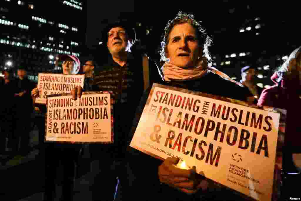 People gather for a candlelight vigil for victims of the truck attack at Foley Square in New York, Nov. 1, 2017.