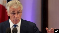 U.S. Defense Secretary Chuck Hagel, right, gestures as he answers questions from reporters during his visit at the Malacanang Presidential Palace in Manila, Philippines, Aug. 30, 2013.