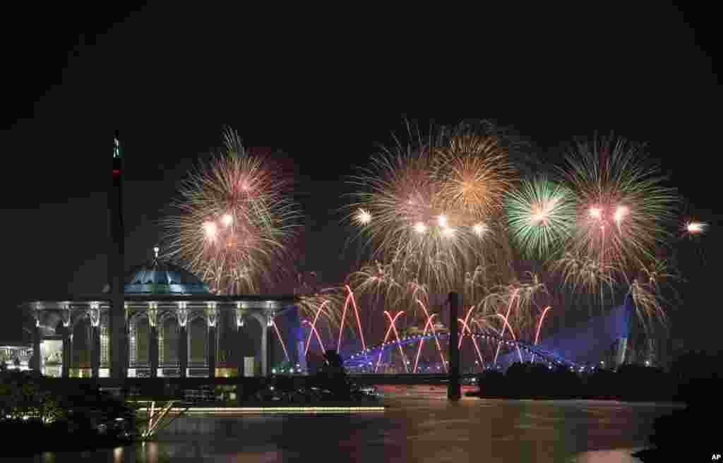 Team Dubai presents fireworks over Malaysia's landmarks Putrajaya Millennium Monument, Tuanku Mizan Zainal Abidin Mosque, left, and Seri Saujana Bridge during the Putrajaya International Fireworks Competition at the administrative capital of Putrajaya outside Kuala Lumpur.